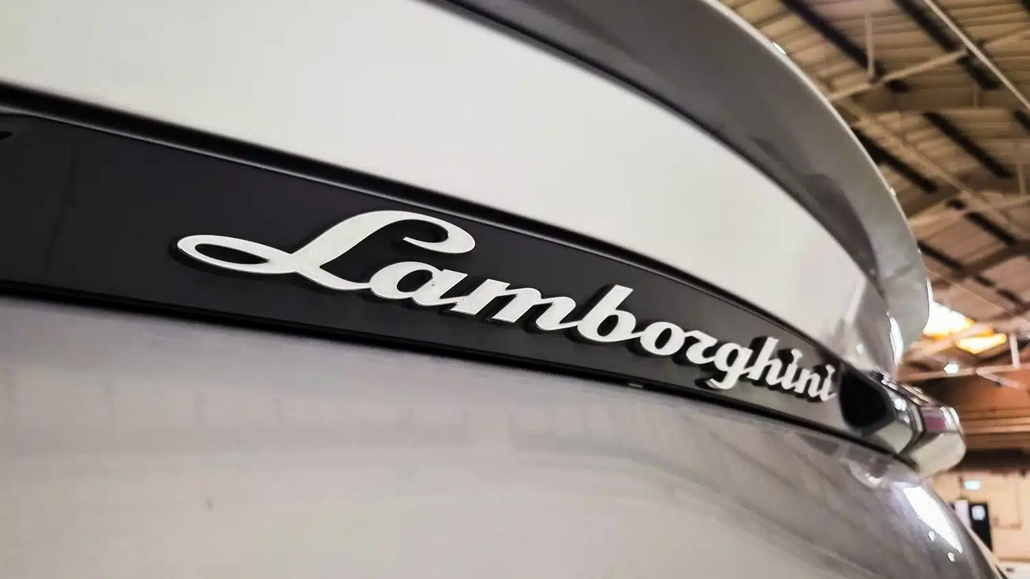 Close up photo of the Lamborghini logo on the rear boot/trunk of a 2021 Lamborghini Urus V8 Auto